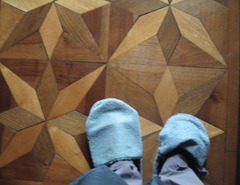 37 slippered feet on floor of Teatro salon